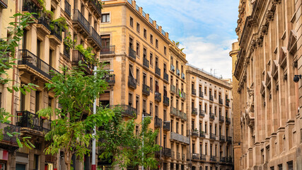 Narrow streets with picturesque old buildings of great beauty in the Gothic Quarter of the city of Barcelona, Spain.