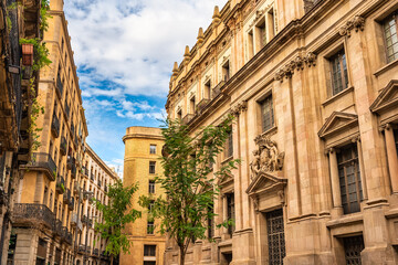 Narrow streets with picturesque old buildings of great beauty in the Gothic Quarter of the city of Barcelona, Spain.