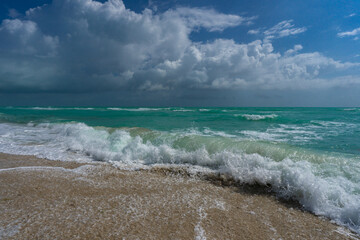 Ocean waves and sand on sky. Stormy sea waves. Summer sea beach wave. Foamy ocean waves. Summer ocean breeze. Dreamy summer beach background. Ocean splash waves.