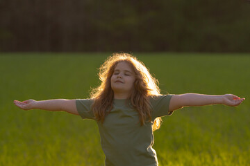 Freedom of dreaming child. Kid enjoying carefree and freedom. Kid meditation in nature. Dreams of...
