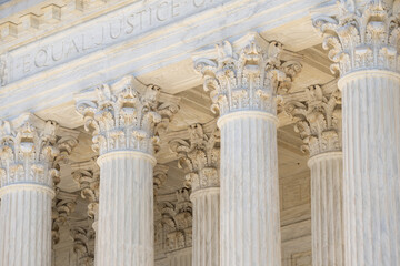 Obraz premium Classical architecture defining monumental columns. Historic government architecture with marble pillars. White stone columns shaping civic architecture. Court house exterior with classical design.