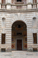 Italy - Caprarola - Palazzo Farnese - Frescoed doorway and stone arch in the circular inner courtyard