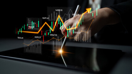 A business professional uses a tablet to analyze financial data with vibrant graphs and charts...
