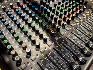 Sliders for volume adjustment and knobs for music control. Professional panel for on stage music control. Concert concept and sound quality control