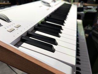 Close up photo of keys of electric piano used to play modern music. Classic electronic musical instrument. Backdrop for concept for learning to play synthesizer