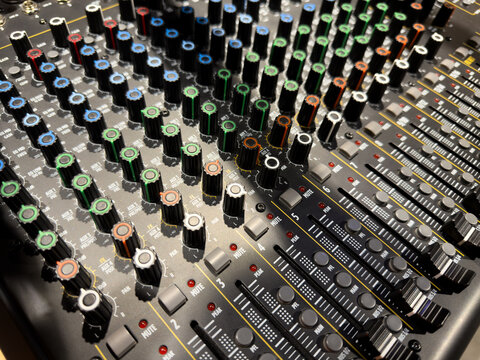 Sliders for volume adjustment and knobs for music control. Professional panel for on stage music control. Concert concept and sound quality control - Powered by Adobe