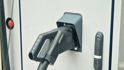 Electric vehicle charging cable connecting to power station