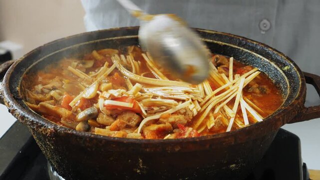 Vegetables with chicken and udon are stewed in a frying pan in Pad Thai sauce and spices