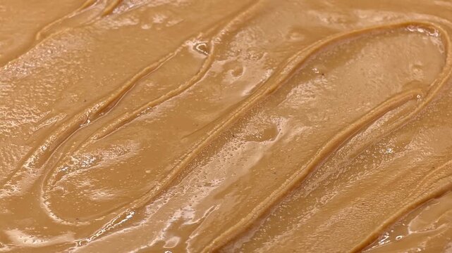 Smooth creamy peanut butter texture. Food background