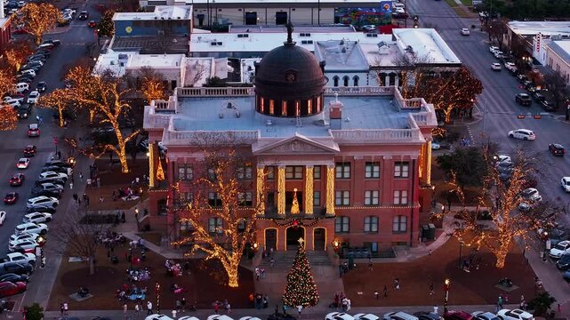 Aerial static drone video of Christmas lights surround the Williamson County Courthouse in downtown Georgetown in Texas in late December 2025
