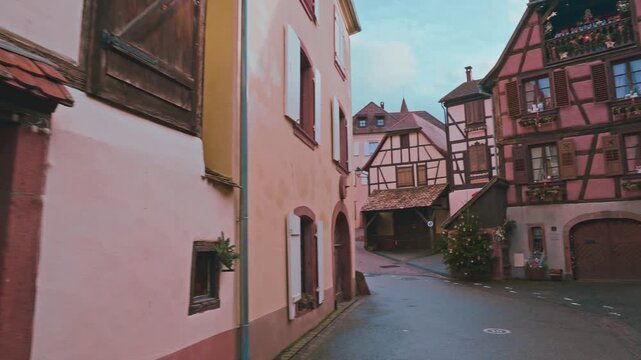 The Alsatian village of Hunawhir with its picturesque pink houses, sloping roofs and half-timbered facades decorated with Christmas decorations