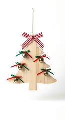A wooden Christmas tree ornament, cut into a tree shape, hangs from a white ribbon. It's decorated with red, green ribbons and bells
