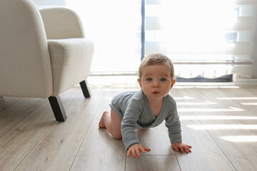 Baby crawling on the floor. Copy space, background.
