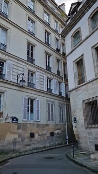 Quiet and historic parisian corner on the ile de la Cite, at the intersection of Rue des Ursins and Rue des Chantres. Reconstructed medieval style buildings with a distinct gothic arched doors