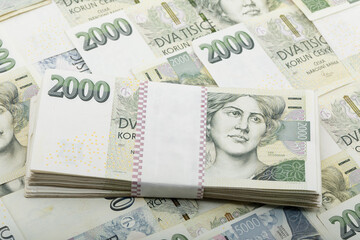 This close-up shot features a bundle of Czech Koruna banknotes, specifically 2000 CZK denominations. Neatly stacked and secured with a paper band, Czech Republic.
