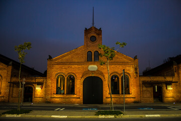 The historical building of the Cinemateca Brasileira (Brazilian Film Library) in Sao Paulo, illuminated at dusk. It is the former municipal slaughterhouse
