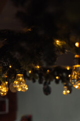 Blurred fir branches with warm holiday lights, cozy bokeh. High quality photo