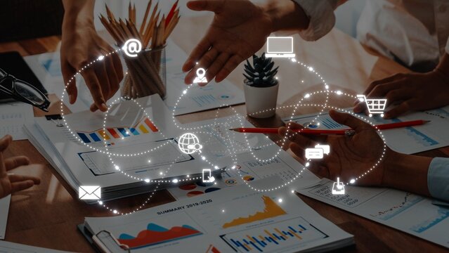 A dynamic team engages in a collaborative discussion, surrounded by data visualization tools and digital communication symbols, showcasing modern business interactions. Raster - Powered by Adobe