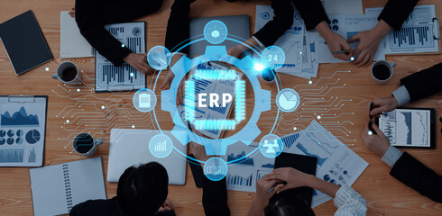 A dynamic business meeting scene with a team analyzing data, surrounded by charts and reports, highlighted by an overlay of an ERP system design for visual engagement. Trope