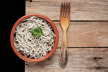 Gulas in a bowl with a wooden fork on a rustic table