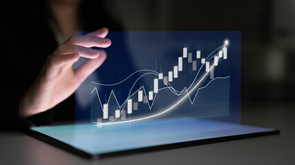 A person interacts with a holographic financial graph displaying positive market trends, showcasing innovation in digital business analysis and strategic growth opportunities. Impute