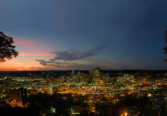 Skyline of Birmingham at sunset with lights shining in the city