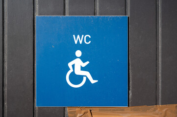 Accessible restroom sign for wheelchair users at Tienen Station, promoting inclusion