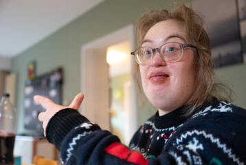 Indoor portrait of a 43-year-old woman with Down Syndrome in a warm family setting © Werner