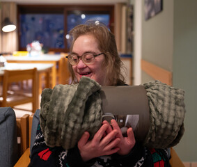 43-year-old woman with Down Syndrome receiving a cozy fleece blanket, full of joy