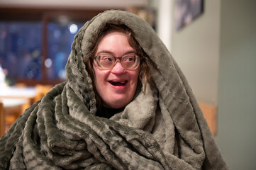 43-year-old woman with Down Syndrome receiving a cozy fleece blanket, full of joy