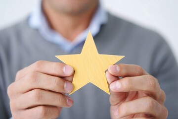 Man Holding a Gold Star - Success, Achievement, and Recognition Concept