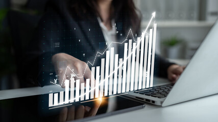 A business professional analyzes financial growth data displayed on a digital interface, emphasizing the importance of analytics in decision-making and strategy development. Impute