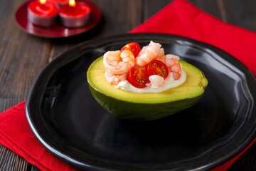 Shrimp Avocado Appetizer with Tomato and Creamy Sauce on Black Plate