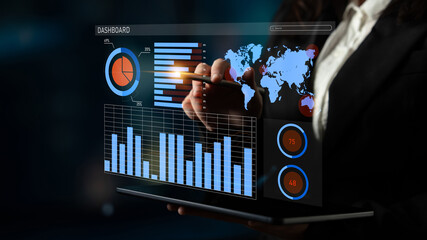 A business professional engages with an interactive data dashboard featuring various graphs and charts, highlighting key insights for strategic decision-making. Impute