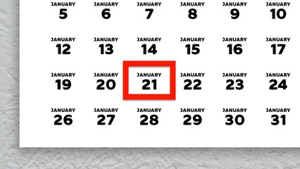 Close-up of the date January 21st marked with a red cursor on the wall calendar 2026