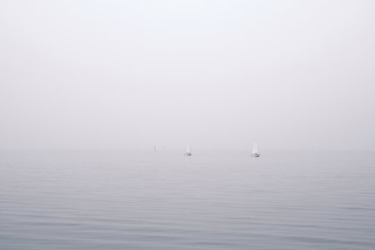 Sail boats on a misty morning sea - Powered by Adobe