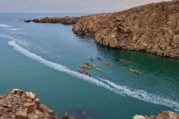 Sea kayakers explores the rugged coasts of Arequipa, navigating turquoise waters and narrow channels carved between ancient rocks. Raw beauty of Peru’s southern shoreline.
