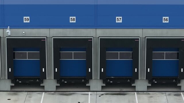 Close-up aerial drone view of a truck loading bay, showcasing logistics and transport infrastructure where freight vehicles are loaded and unloaded as part of modern supply chain operations.