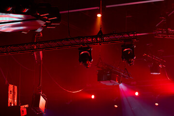 Overhead view of stage lighting truss with moving heads and projection screen