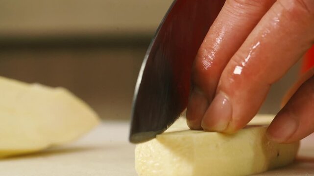 Slicing Sweet Potato on Cutting Board 