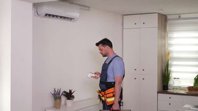 Repairing an air conditioner in a modern kitchen during the daytime