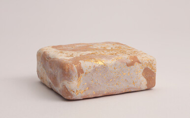 Beige white, gold glitter marble Stones platform podium on gray neutral natural background. Minimal empty display product presentation scene.