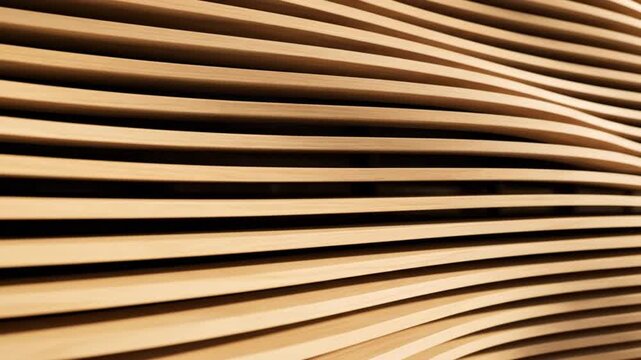 This video features a seamless, abstract close-up of a modern interior wall, adorned with beautifully crafted horizontal wooden slats arranged in a flowing, undulating wave pattern. The natural light 