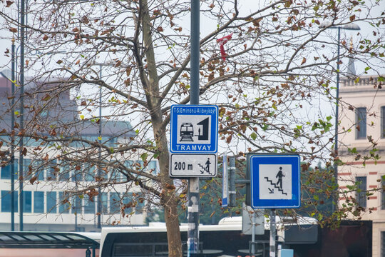 Tramvay Direction Sign and Pedestrian Information Wayfinding Post for T5 Eminonu Alibeykoy Line in Istanbul Turkey Square with Trees and City Buildings in Background