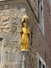 Gilded figure on a street corner