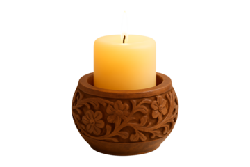 Carved wooden candle holder with burning yellow wax candle flame creating cozy warm atmosphere for relaxation meditation and spiritual interior home decor on dark background