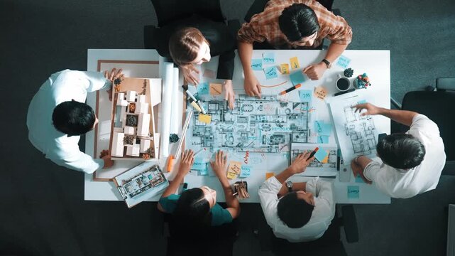 Top view of smart manager clapping hands and putting hands together to celebrate project. Aerial view of architect engineer brainstorming about interior construction. Team work, unity. Alimentation.