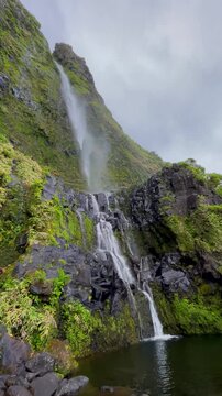 Poco do Bacalhau waterfall with lush greenery