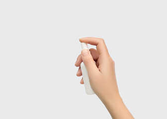 Hand holding and pressing a white spray bottle