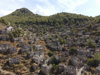 Obraz premium Aerial view of Kayaköy, a historic abandoned village set on a hillside near Fethiye, Turkey